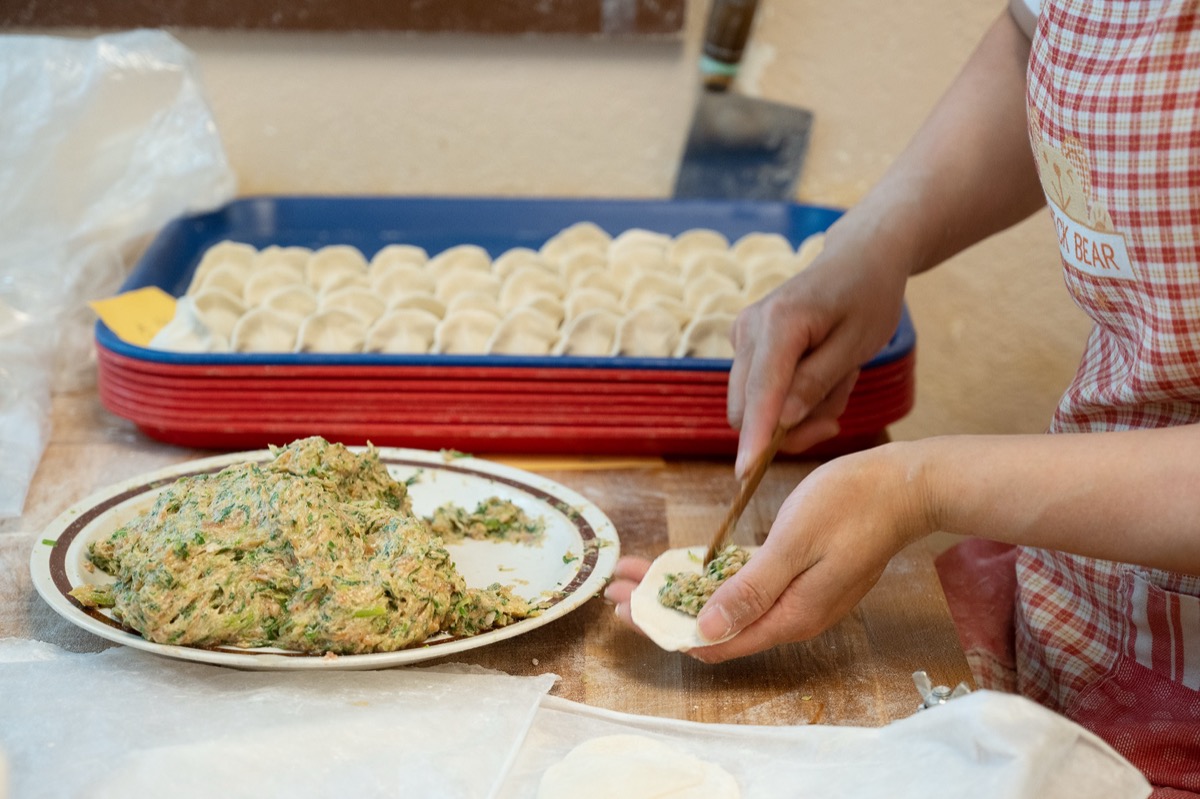 Artisan handmaking dumplings with care and precision