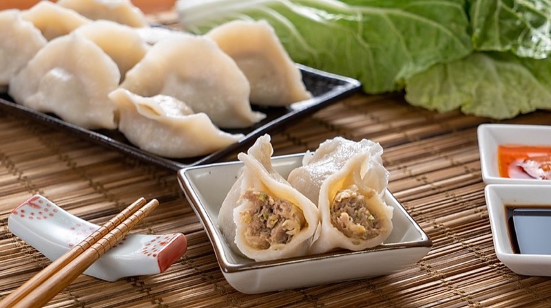 Handmade boiled dumplings cut open showing fresh filling
